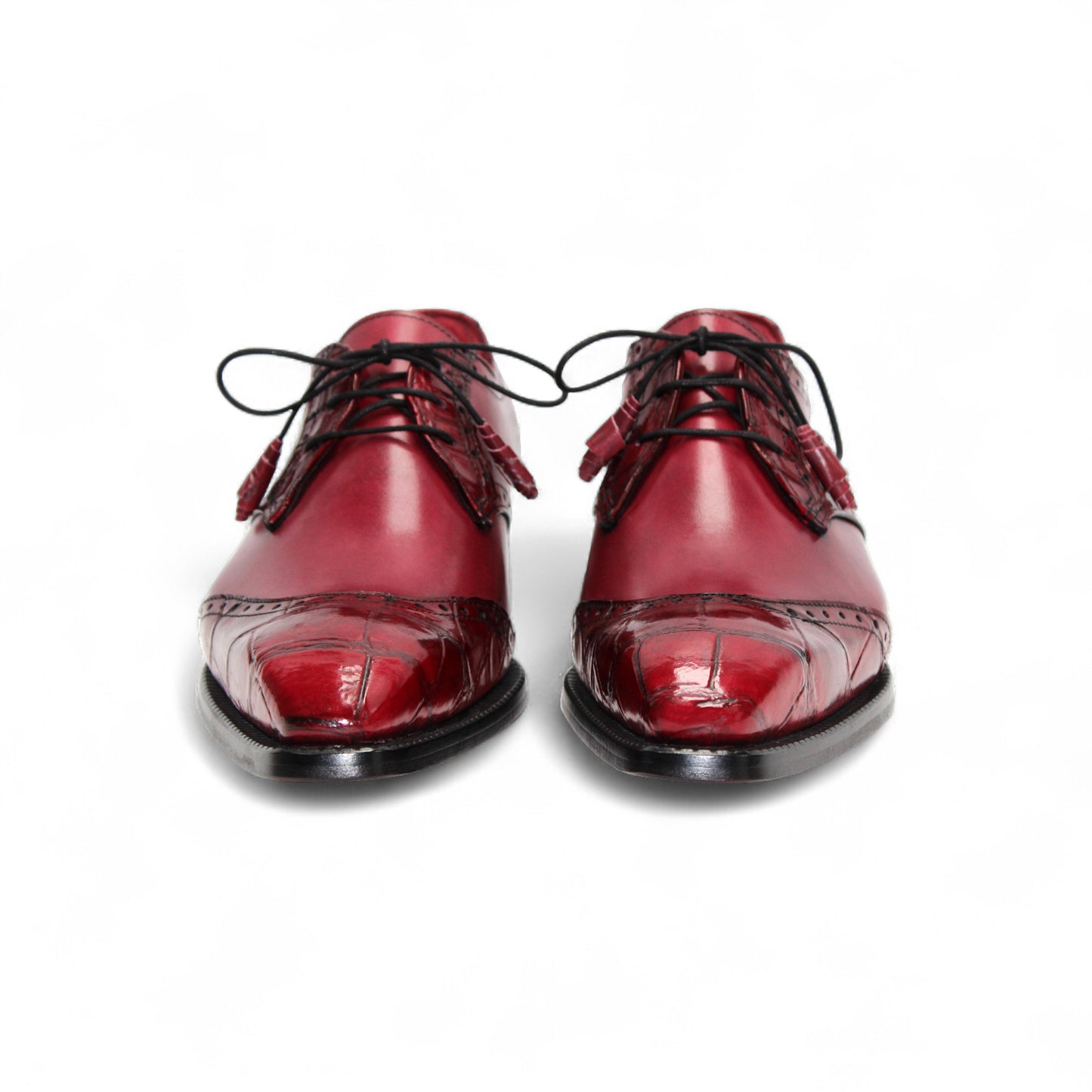 The Fennix Jax Antique Red by Fennix of Italy is a men's red leather dress shoe featuring decorative perforations, black laces, and a low black heel, exemplifying Italian craftsmanship and luxury on a white background.