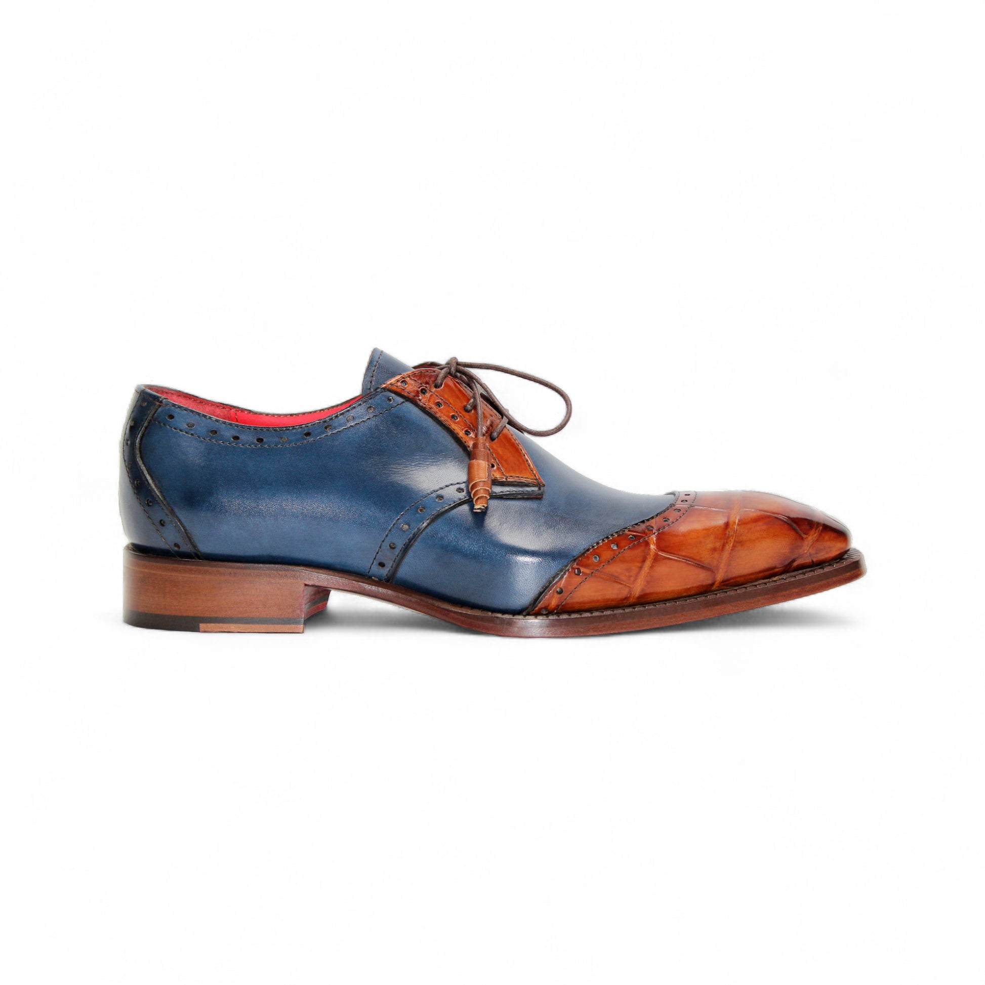 The Fennix Jax Cognac/Navy by Fennix of Italy is a luxury men's dress shoe with a blue leather upper, brown leather toe and heel accents, brogue details, brown laces, and Italian craftsmanship, shown in profile on a plain white background.