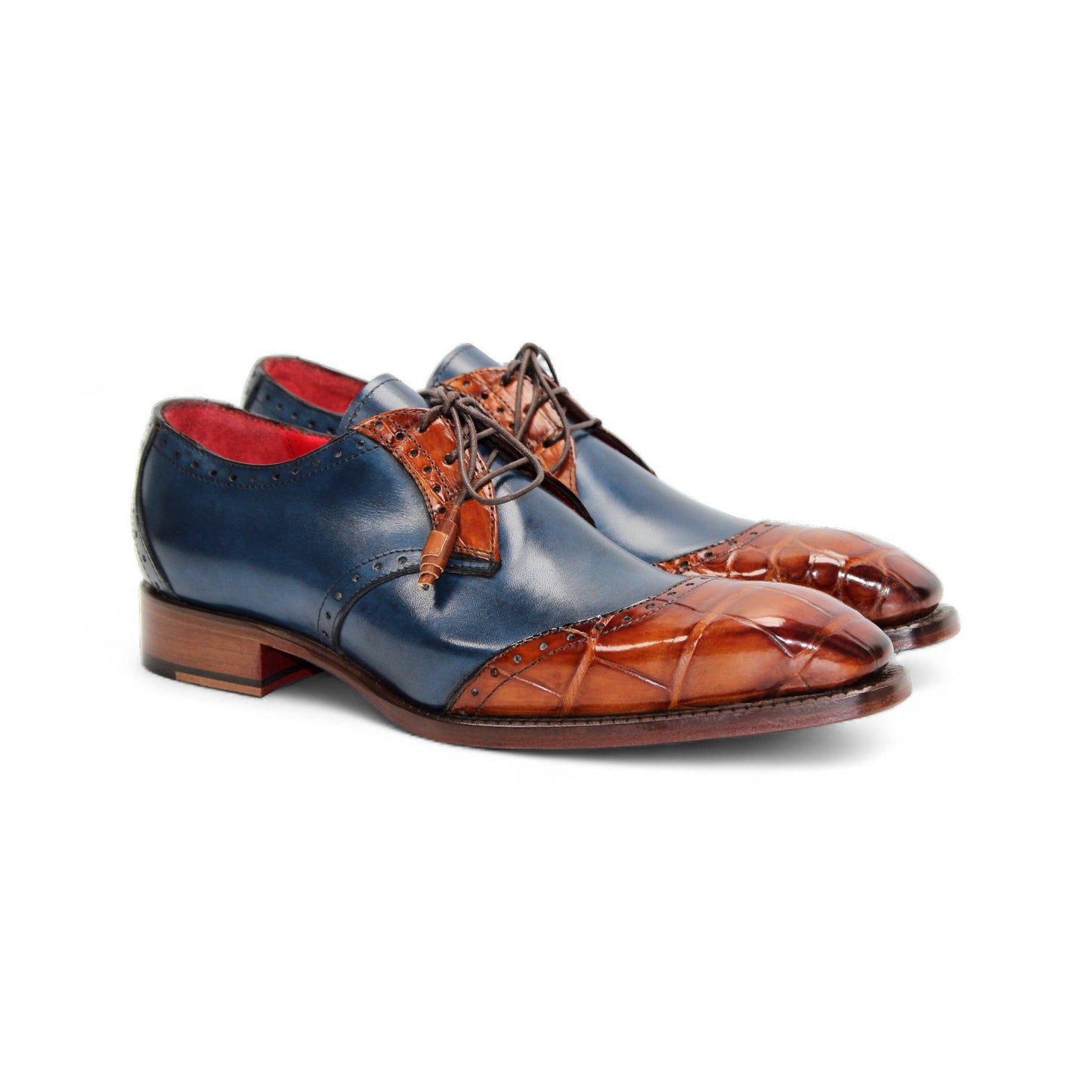 The Fennix Jax Cognac/Navy by Fennix of Italy is a luxury men's dress shoe with a blue leather upper, brown leather toe and heel accents, brogue details, brown laces, and Italian craftsmanship, shown in profile on a plain white background.
