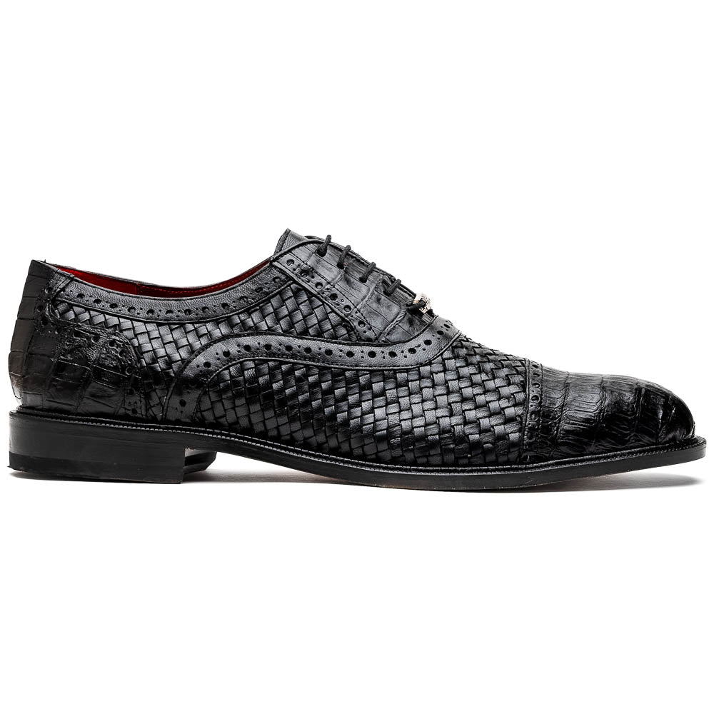A pair of luxury "John Black" dress oxfords by Marco Di Milano, crafted from genuine caiman crocodile leather with intricate detailing and brown leather soles—one upright, the other resting sideways beneath it.