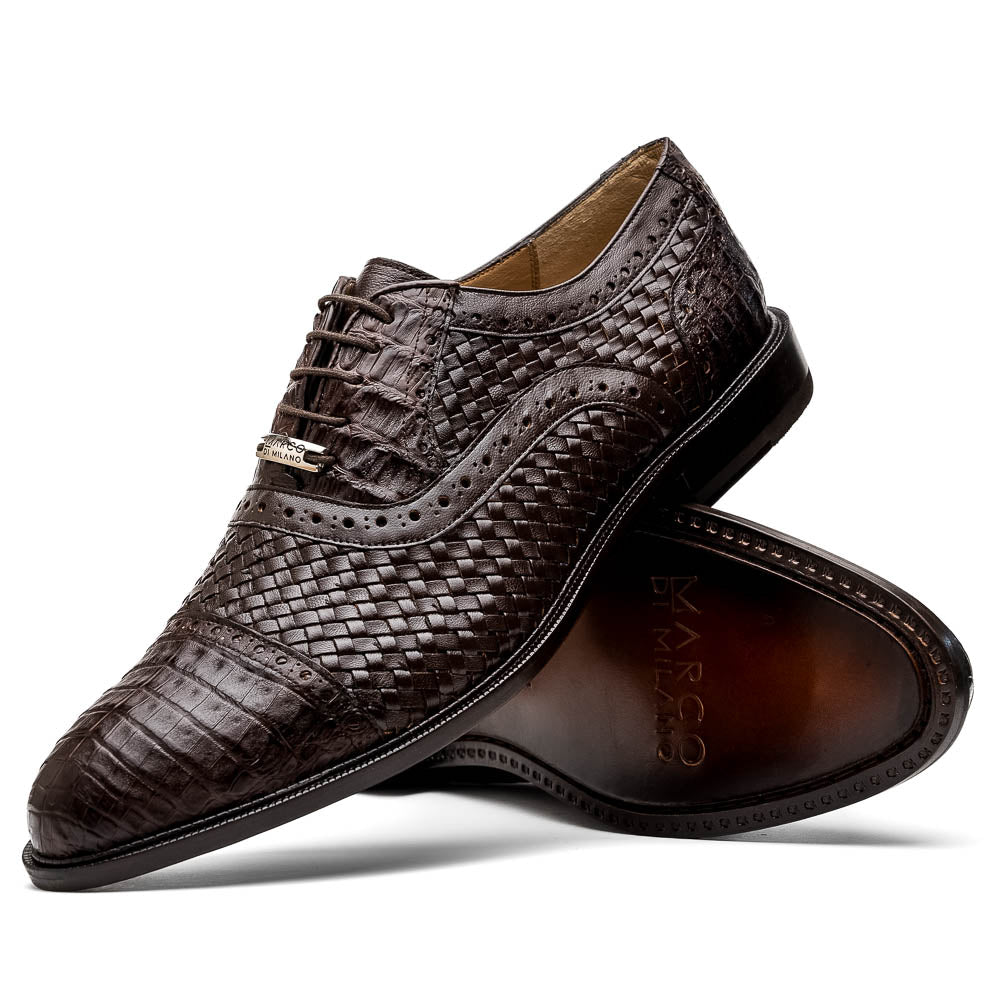 A pair of John Brown luxury dress oxfords by Marco Di Milano in brown woven calfskin leather with brogue detailing; one shoe upright, the other displays the sole and "Marco Di Milano" branding.