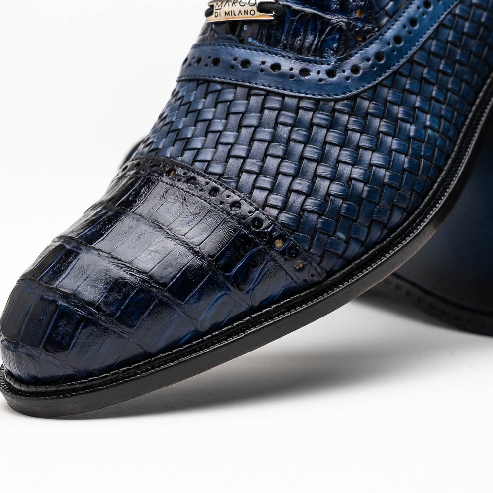 Introducing the Marco Di Milano John Navy: luxury dark blue woven oxford shoes in genuine caiman crocodile leather, with one shoe showing the sole and the other upright.
