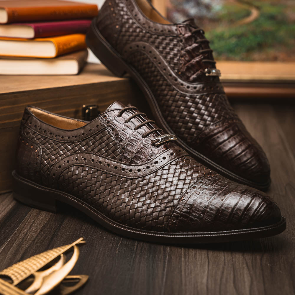 A pair of John Brown luxury dress oxfords by Marco Di Milano in brown woven calfskin leather with brogue detailing; one shoe upright, the other displays the sole and "Marco Di Milano" branding.