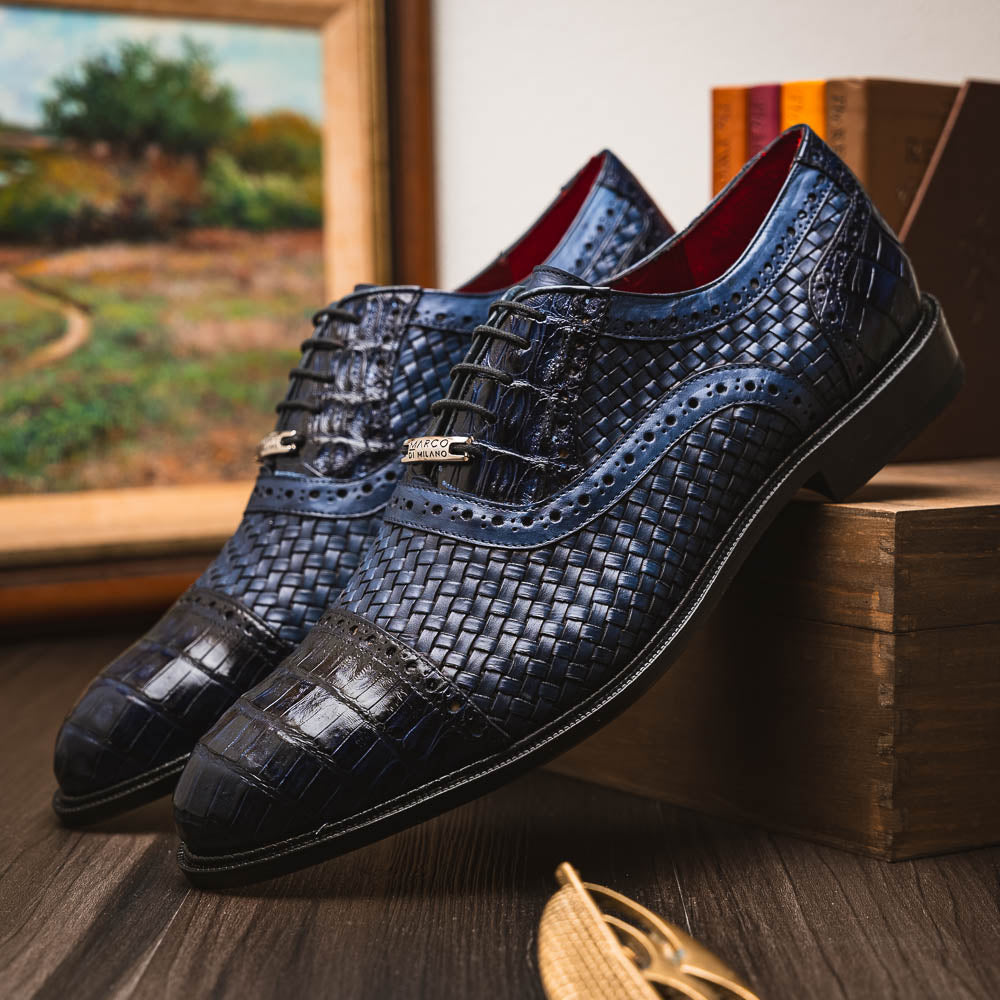 Introducing the Marco Di Milano John Navy: luxury dark blue woven oxford shoes in genuine caiman crocodile leather, with one shoe showing the sole and the other upright.