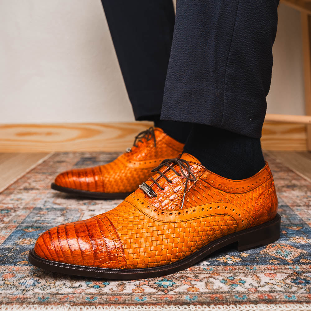 The John Brandy by Marco Di Milano is a pair of brown men’s oxford dress shoes with woven and textured leather, black laces, and stitched leather soles—ideal for those seeking luxury footwear.