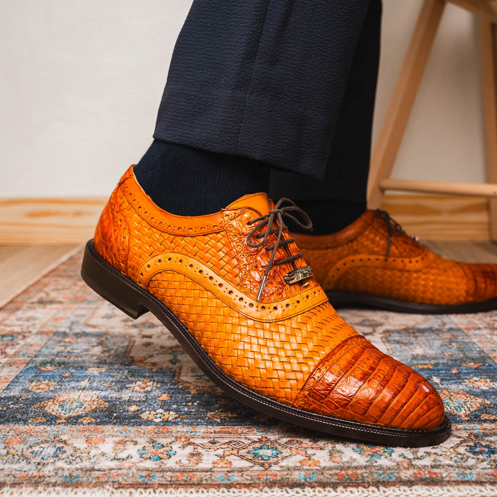 The John Brandy by Marco Di Milano is a pair of brown men’s oxford dress shoes with woven and textured leather, black laces, and stitched leather soles—ideal for those seeking luxury footwear.