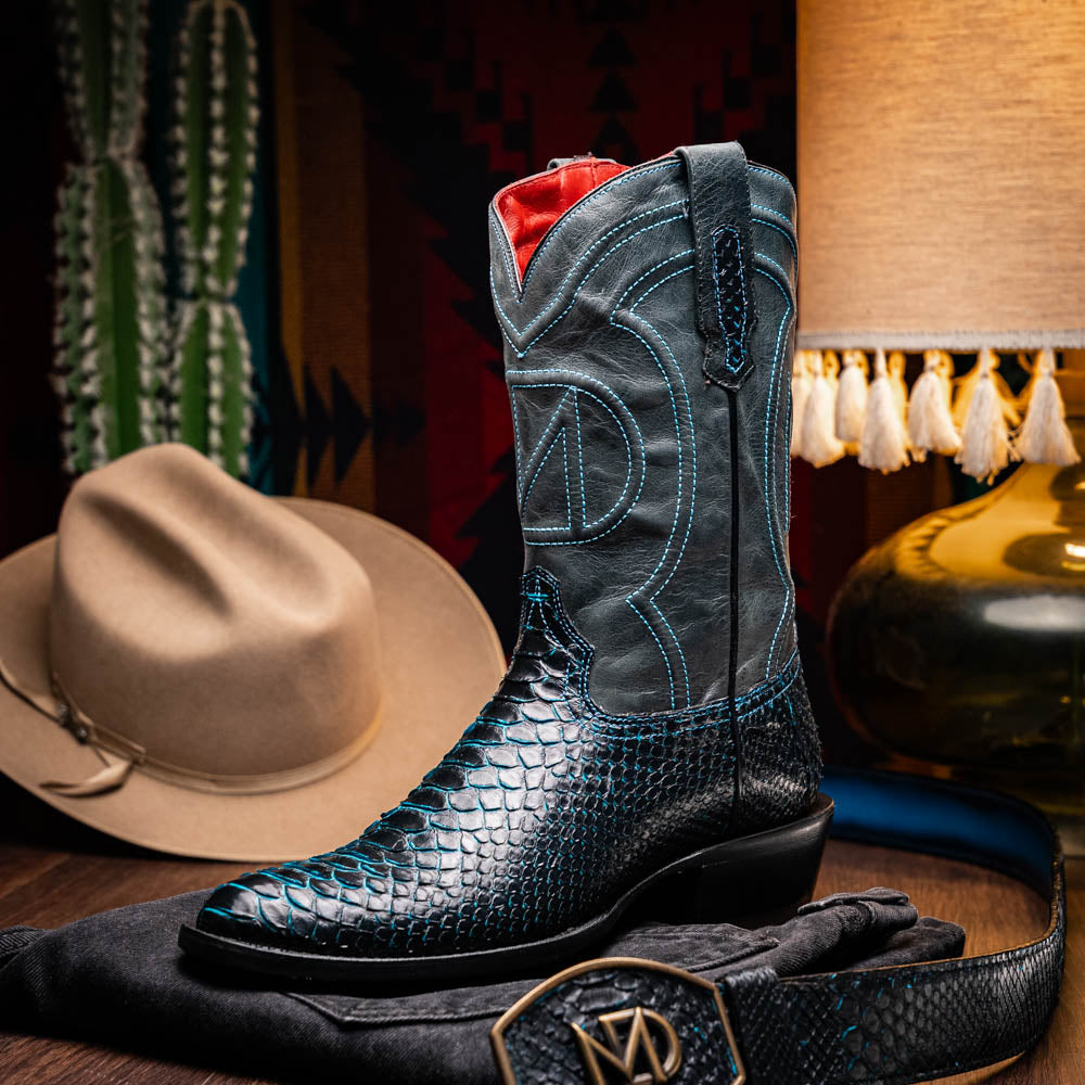 The Marco Di Milano Kansas Black / Blue boots feature black leather with blue stitching, a snakeskin texture, and branded soles—a luxurious handcrafted pair designed to stand out.