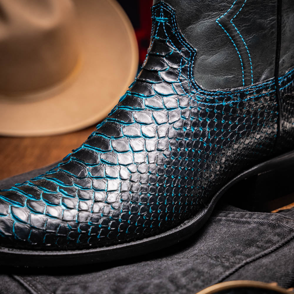 The Marco Di Milano Kansas Black / Blue boots feature black leather with blue stitching, a snakeskin texture, and branded soles—a luxurious handcrafted pair designed to stand out.