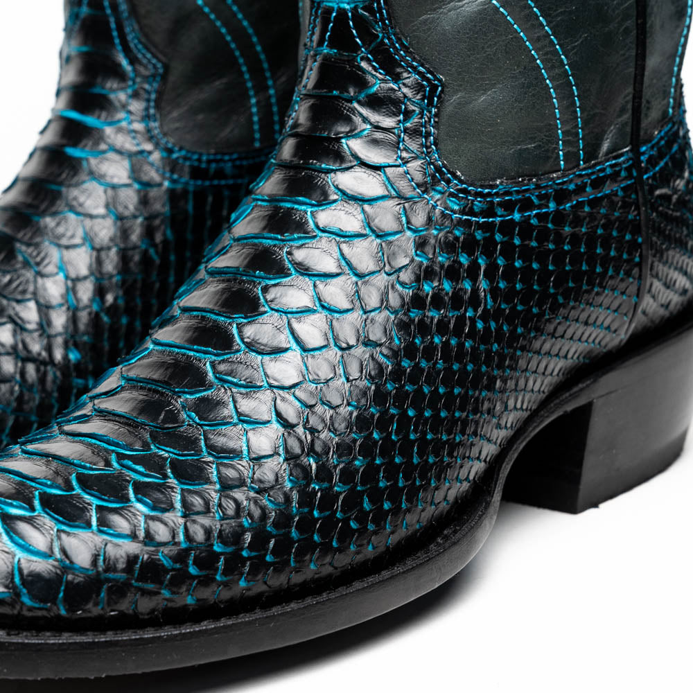 The Marco Di Milano Kansas Black / Blue boots feature black leather with blue stitching, a snakeskin texture, and branded soles—a luxurious handcrafted pair designed to stand out.