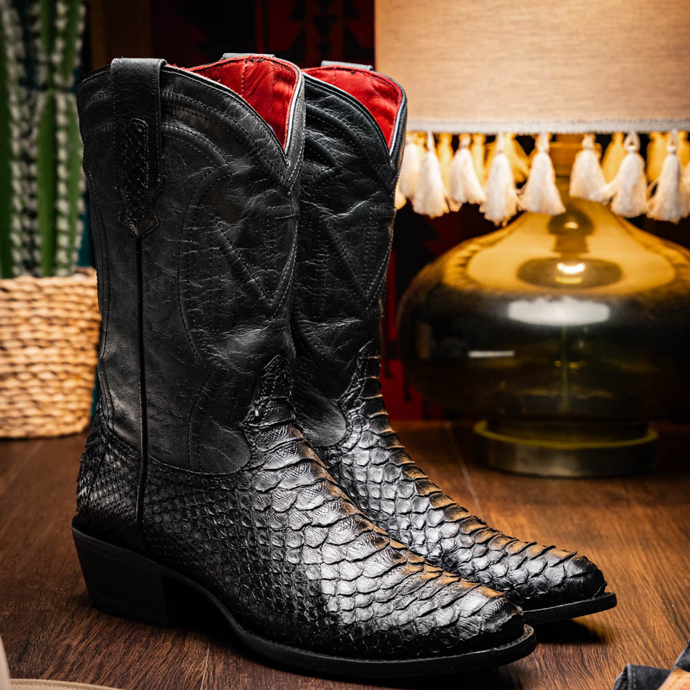 A pair of Kansas Black genuine python boots by Marco Di Milano, one upright and one on its side showing the branded sole.