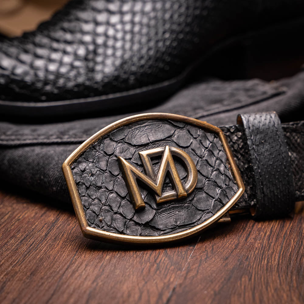 A pair of Kansas Black genuine python boots by Marco Di Milano, one upright and one on its side showing the branded sole.