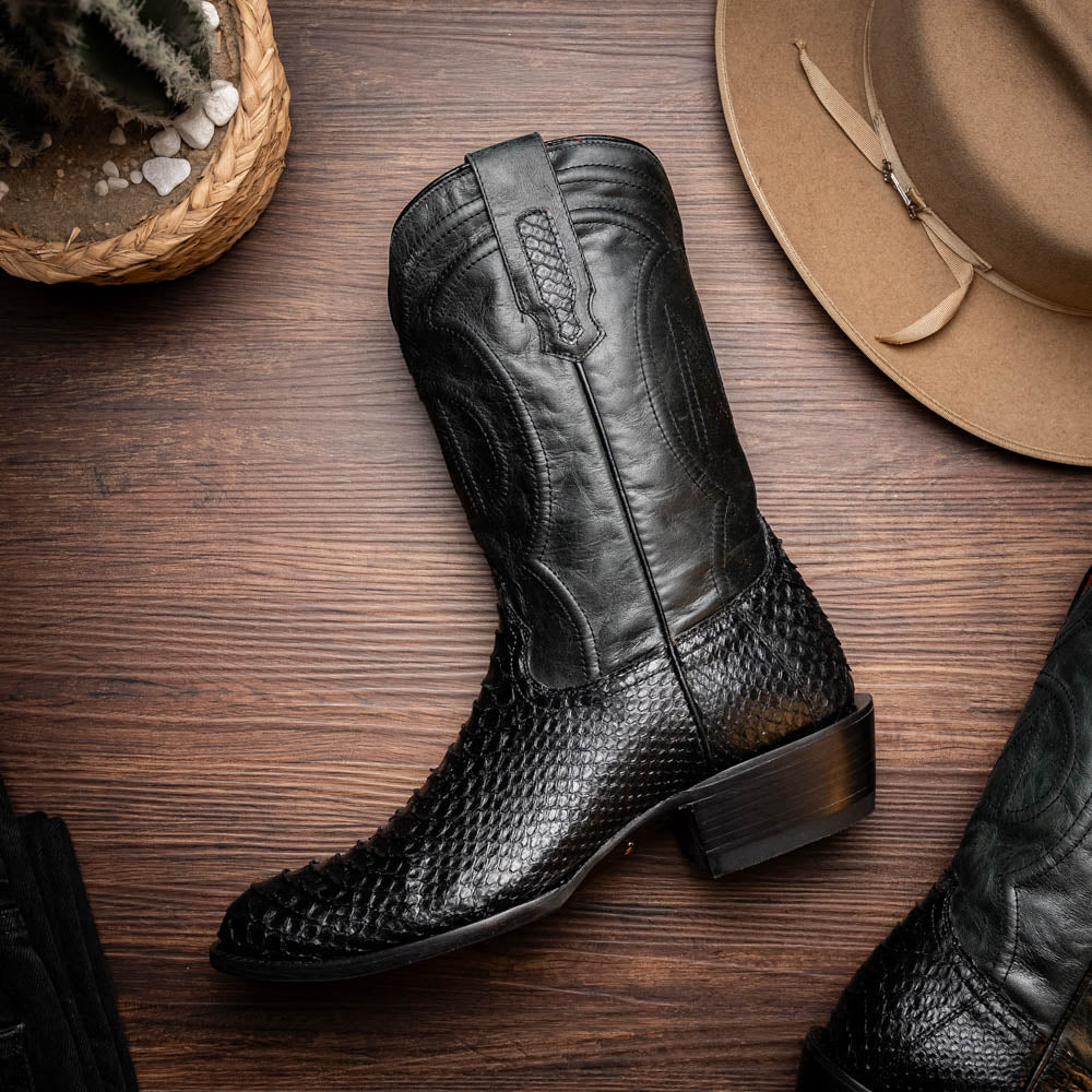 A pair of Kansas Black genuine python boots by Marco Di Milano, one upright and one on its side showing the branded sole.