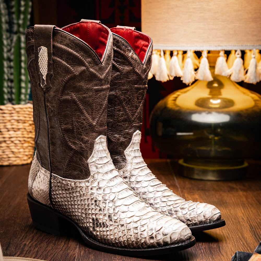 Marco Di Milano's Kansas Natural boots feature white python skin on the foot and brown textured leather on the shaft; one boot stands upright, while the other shows the branded sole.