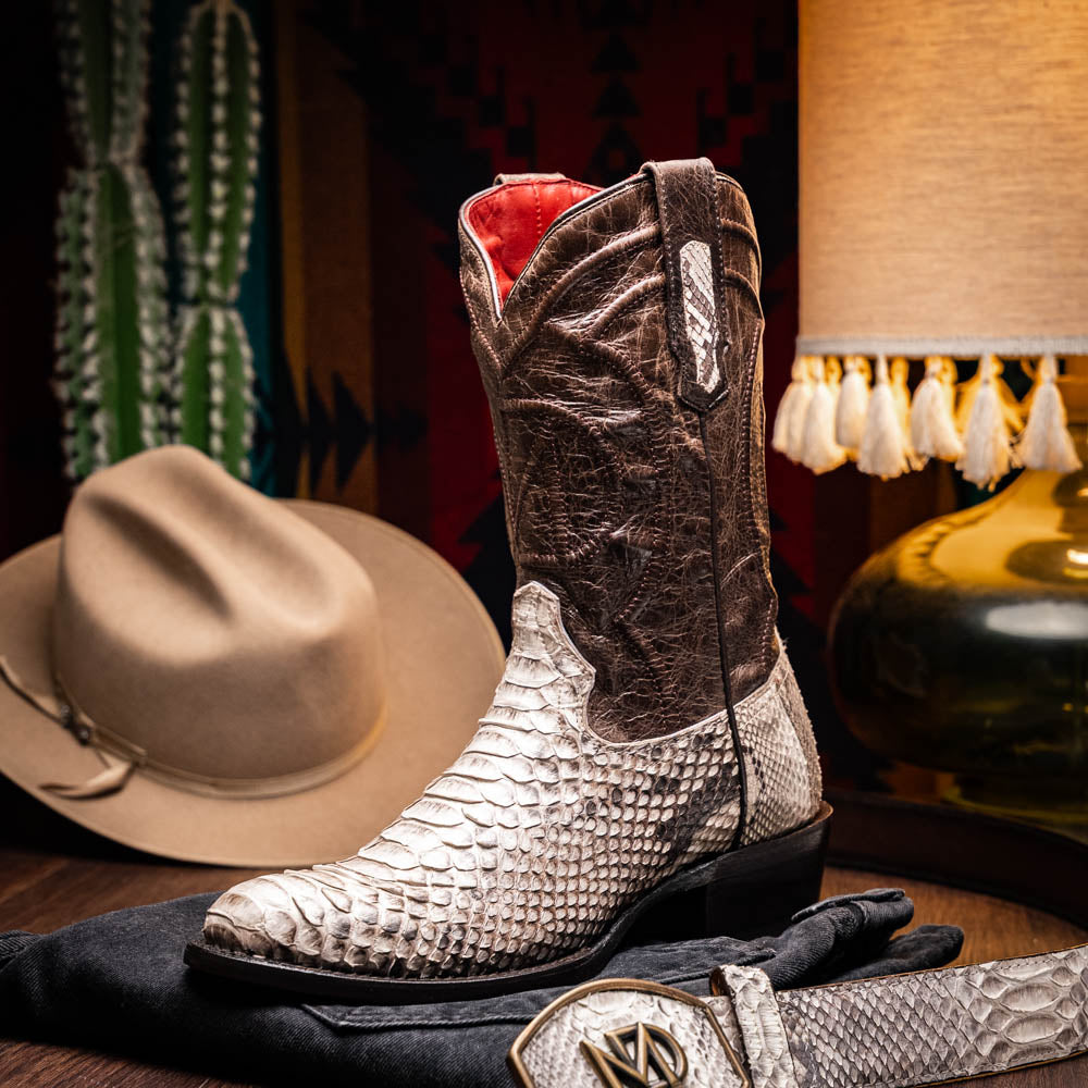 Marco Di Milano's Kansas Natural boots feature white python skin on the foot and brown textured leather on the shaft; one boot stands upright, while the other shows the branded sole.