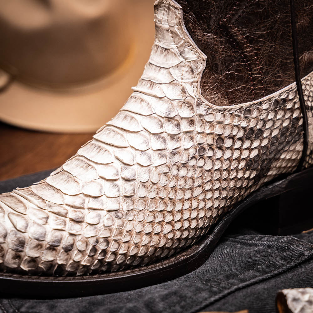 Marco Di Milano's Kansas Natural boots feature white python skin on the foot and brown textured leather on the shaft; one boot stands upright, while the other shows the branded sole.