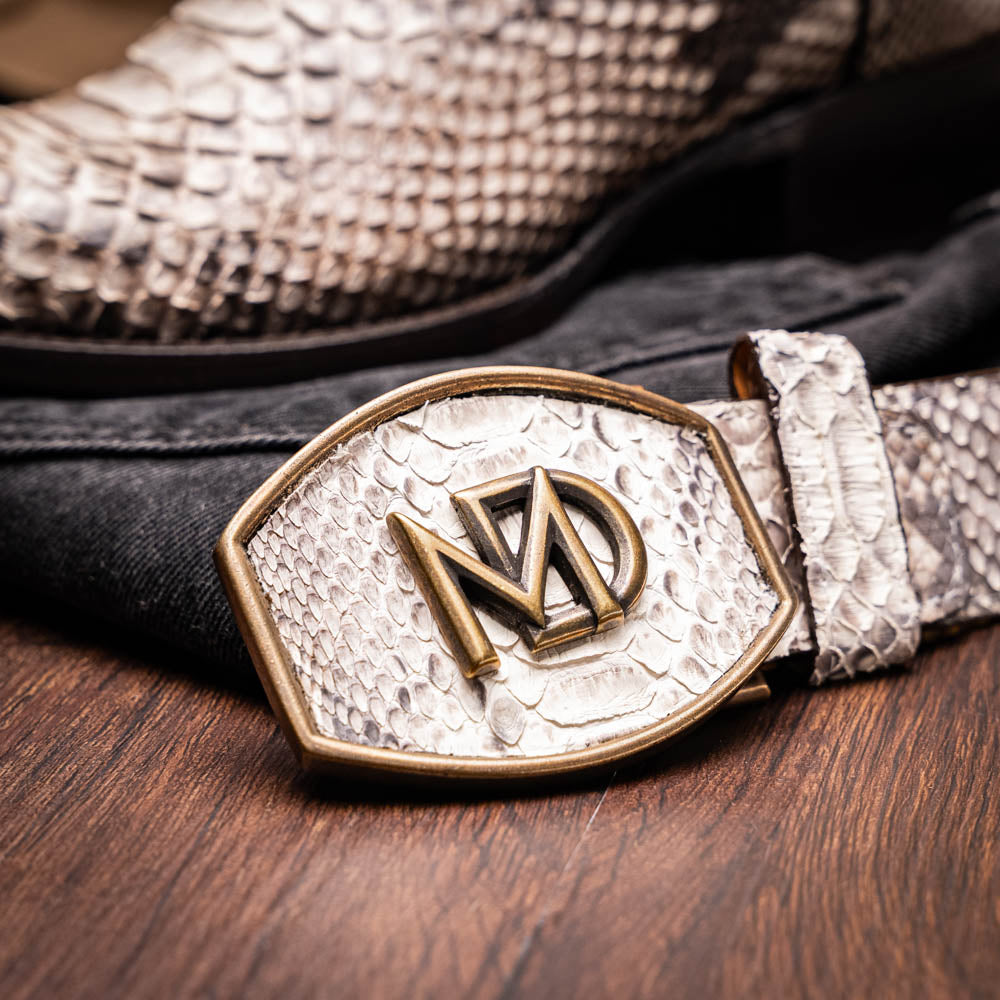 Marco Di Milano's Kansas Natural boots feature white python skin on the foot and brown textured leather on the shaft; one boot stands upright, while the other shows the branded sole.