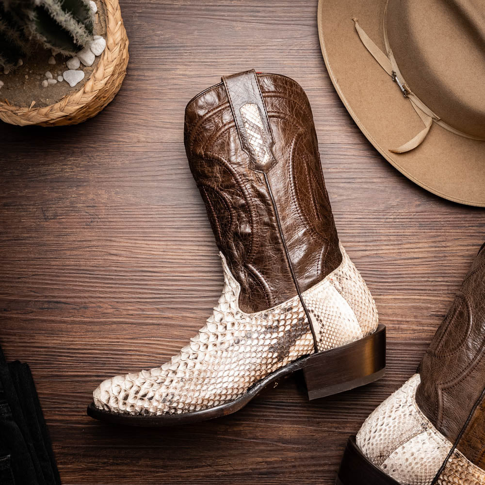 Marco Di Milano's Kansas Natural boots feature white python skin on the foot and brown textured leather on the shaft; one boot stands upright, while the other shows the branded sole.