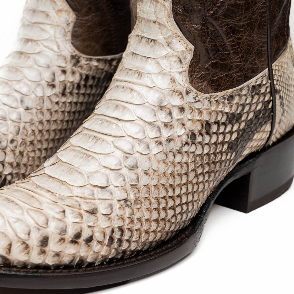 Marco Di Milano's Kansas Natural boots feature white python skin on the foot and brown textured leather on the shaft; one boot stands upright, while the other shows the branded sole.
