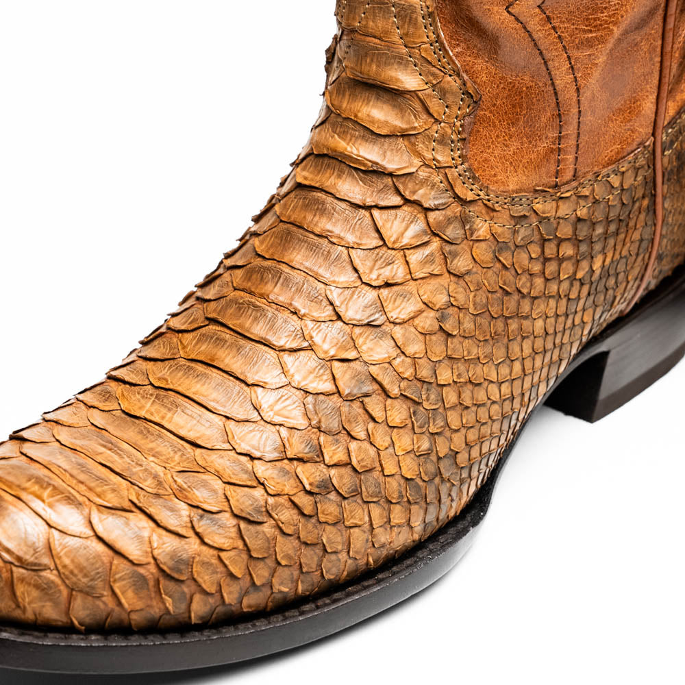 A pair of Kansas Cognac cowboy boots by Marco Di Milano in brown genuine python skin, featuring textured scales—one boot upright, the other showing the branded sole.