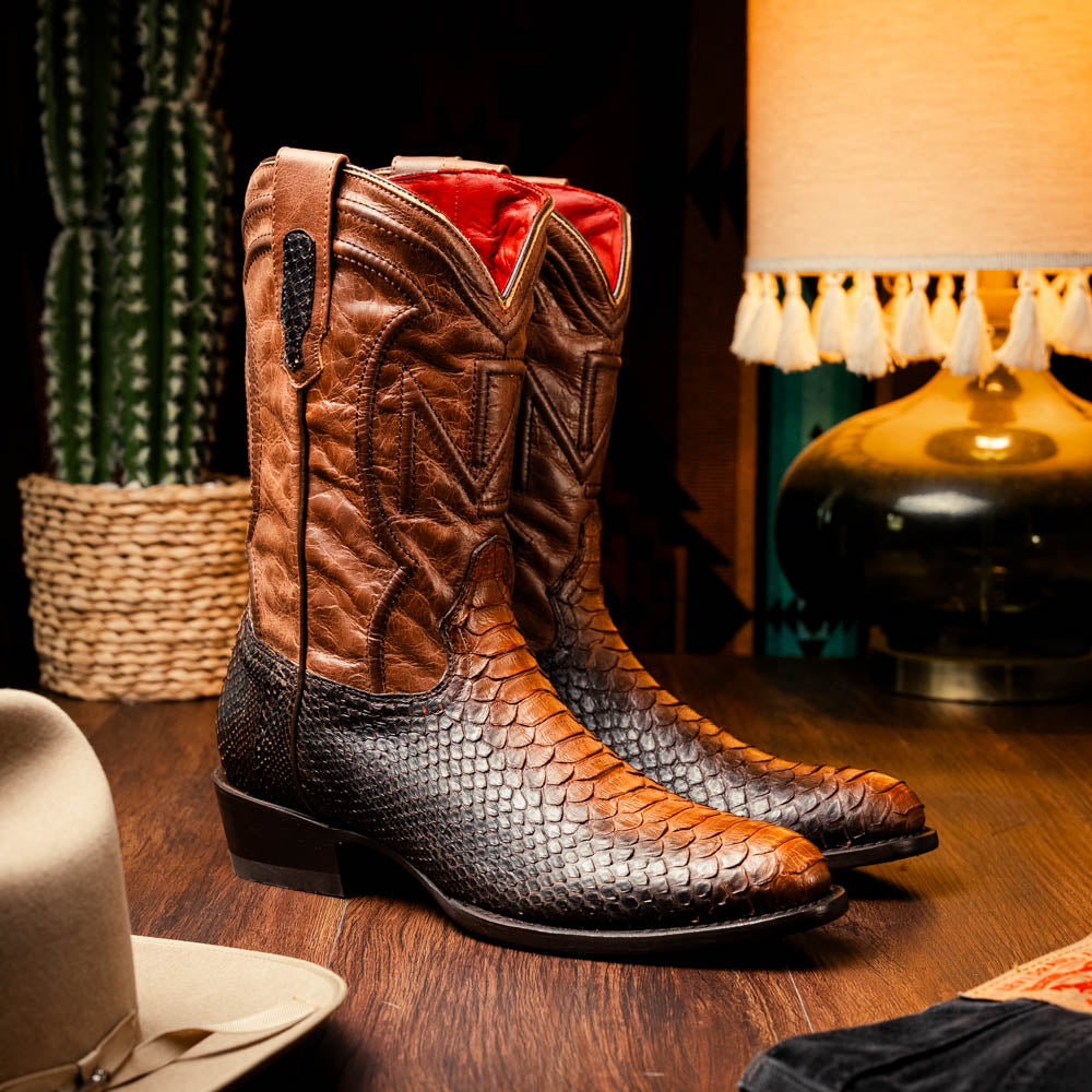 A pair of Kansas Lisboa boots by Marco Di Milano in brown and black python leather, featuring textured scales; one boot stands upright while the other displays the branded sole with "Marco Di Milano" text.