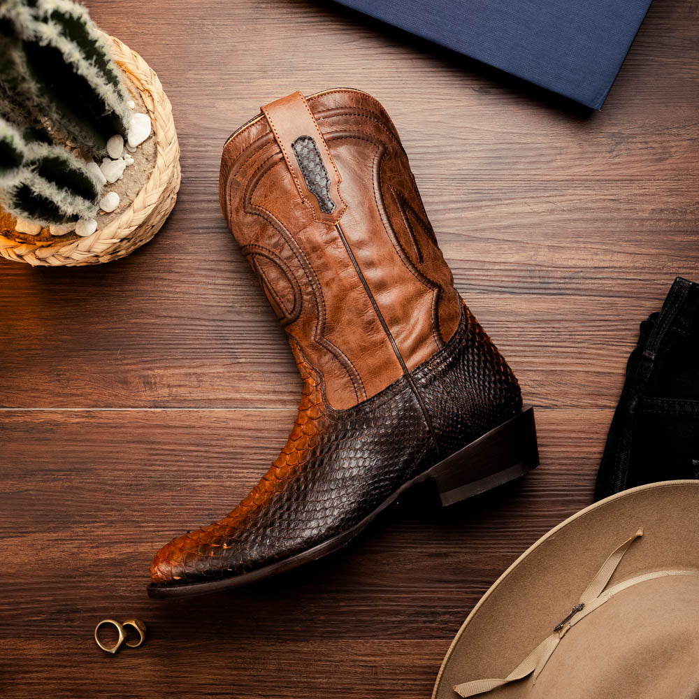 A pair of Kansas Lisboa boots by Marco Di Milano in brown and black python leather, featuring textured scales; one boot stands upright while the other displays the branded sole with "Marco Di Milano" text.