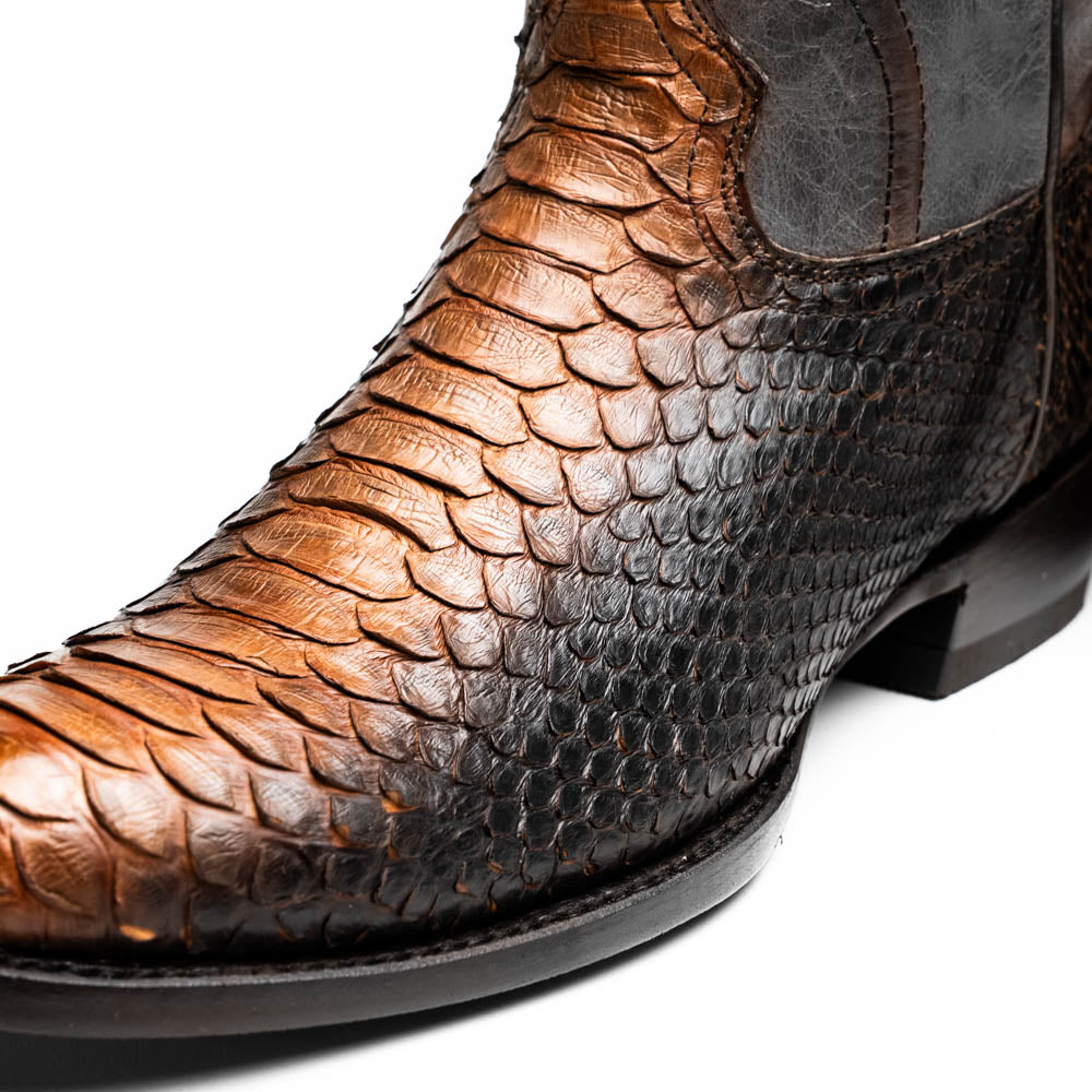 A pair of Kansas Lisboa boots by Marco Di Milano in brown and black python leather, featuring textured scales; one boot stands upright while the other displays the branded sole with "Marco Di Milano" text.