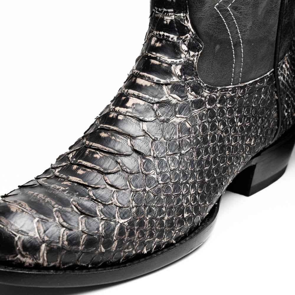 A pair of Kansas Stone White Western cowboy boots by Marco Di Milano, featuring textured, snakeskin-like leather and decorative stitching; one boot stands upright, the other shows the branded sole.