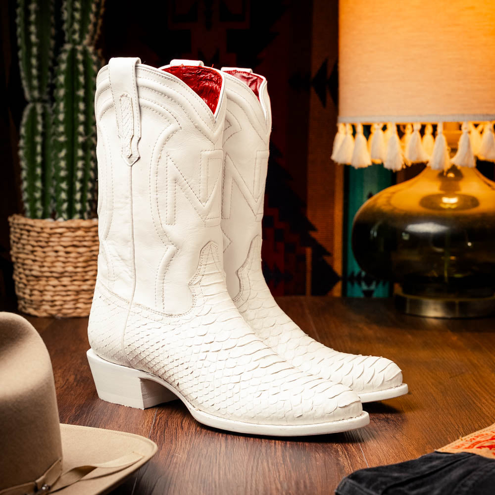 A pair of Kansas White cowboy boots by Marco Di Milano in white textured python skin with pointed toes and low heels; one boot stands upright while the other shows the branded sole.