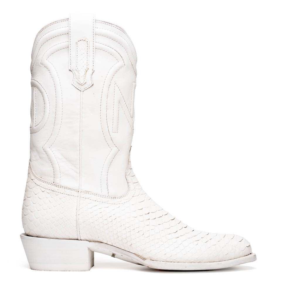 A pair of Kansas White cowboy boots by Marco Di Milano in white textured python skin with pointed toes and low heels; one boot stands upright while the other shows the branded sole.