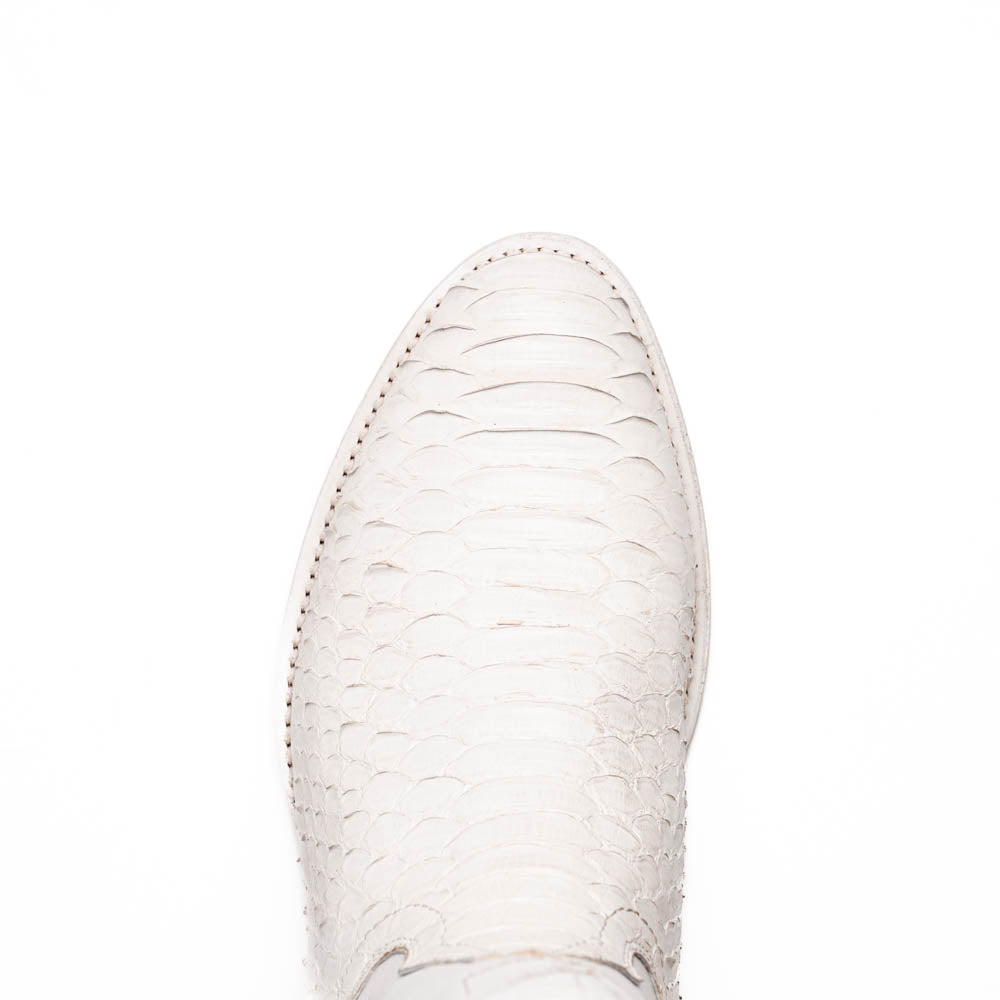 A pair of Kansas White cowboy boots by Marco Di Milano in white textured python skin with pointed toes and low heels; one boot stands upright while the other shows the branded sole.