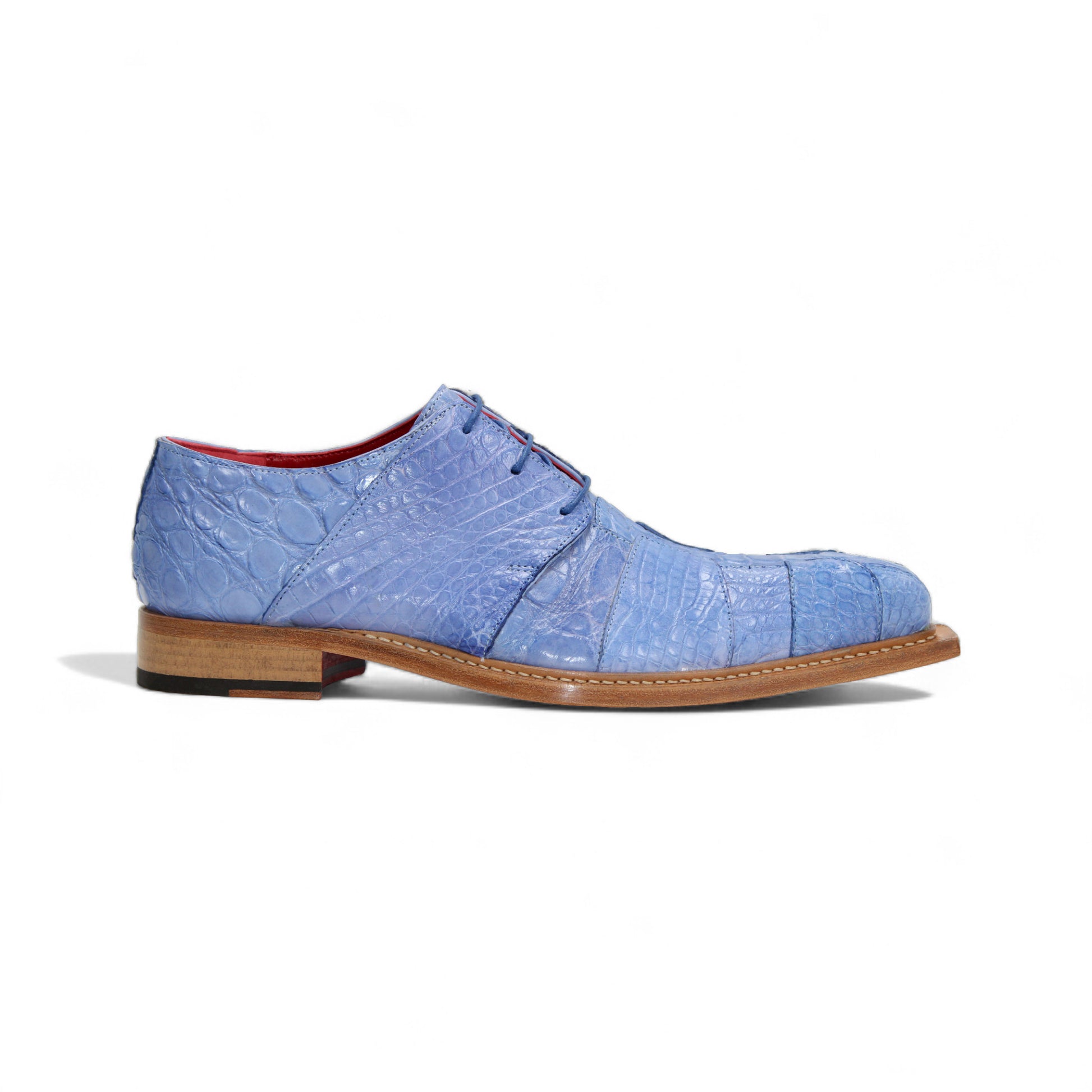 The Fennix Kingston Light Blue by Fennix of Italy is a stylish genuine alligator leather shoe with Italian craftsmanship and a wooden sole, shown from the side on a white background.