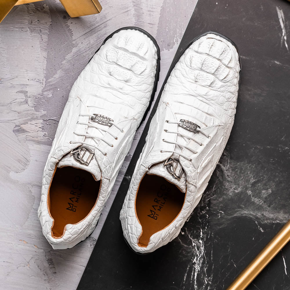 Kratos White by Marco Di Milano: luxury white crocodile-patterned leather dress shoes with black rubber soles—one upright, the other on its side.