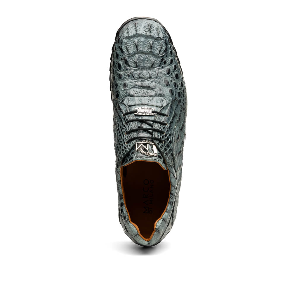 The Kratos Gray by Marco Di Milano are luxury dress shoes in textured gray crocodile-patterned leather with a hand-painted finish and black rubber soles; one shoe stands upright while the other rests on its side.