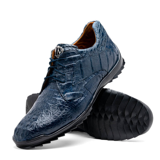 The Kratos Navy by Marco Di Milano: blue hand-painted crocodile-patterned leather dress shoes with black rubber soles—one upright, the other propped—a true statement of luxury footwear.