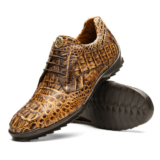 A pair of Kratos Rustic Orix brown crocodile-patterned leather dress shoes by Marco Di Milano, one upright and one tilted to display the textured sole, showcasing luxury footwear against a white background.