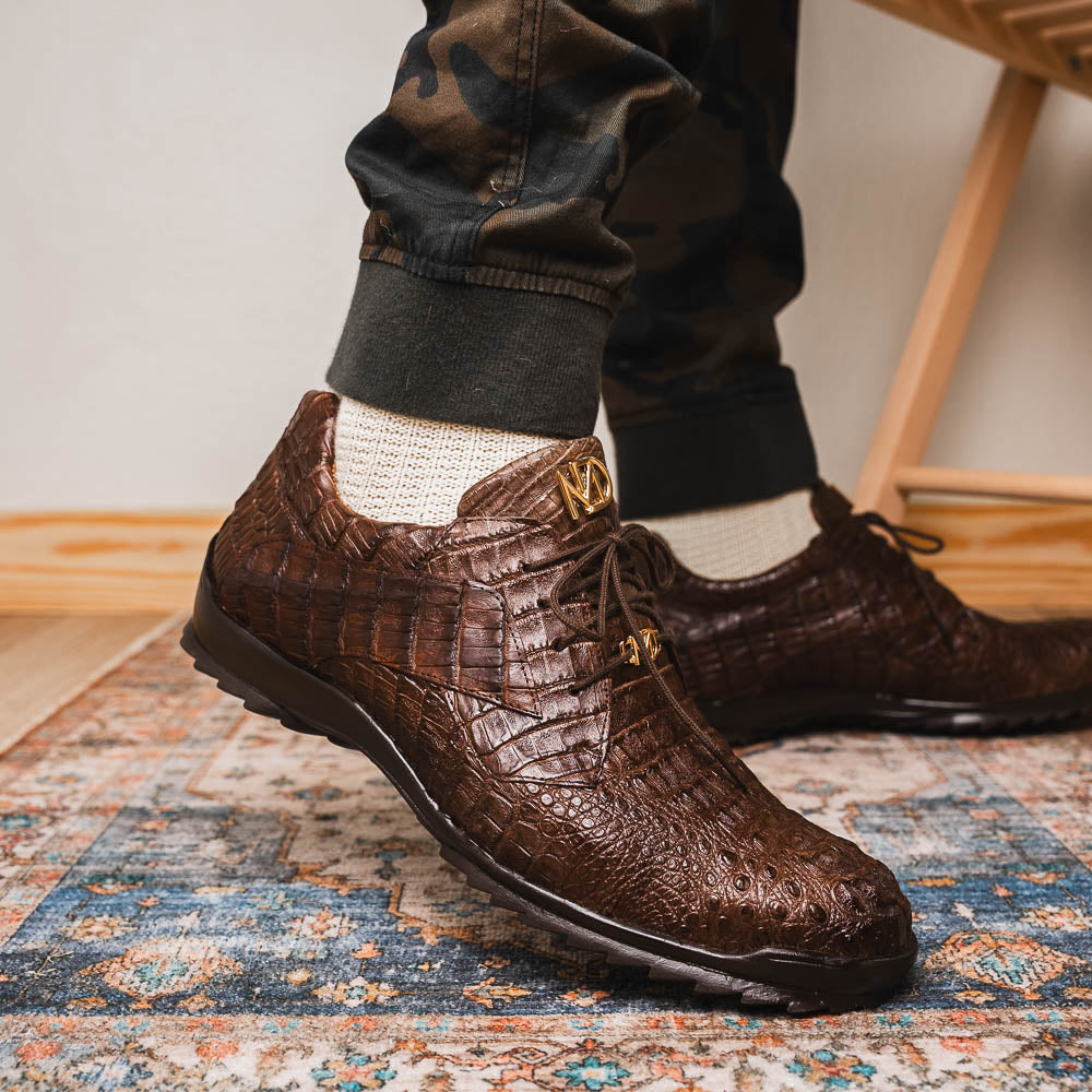 The Kratos Brown by Marco Di Milano features genuine caiman crocodile leather, a hand-painted brown finish, black soles, and gold lace accents—ideal luxury dress shoes for the discerning wearer.