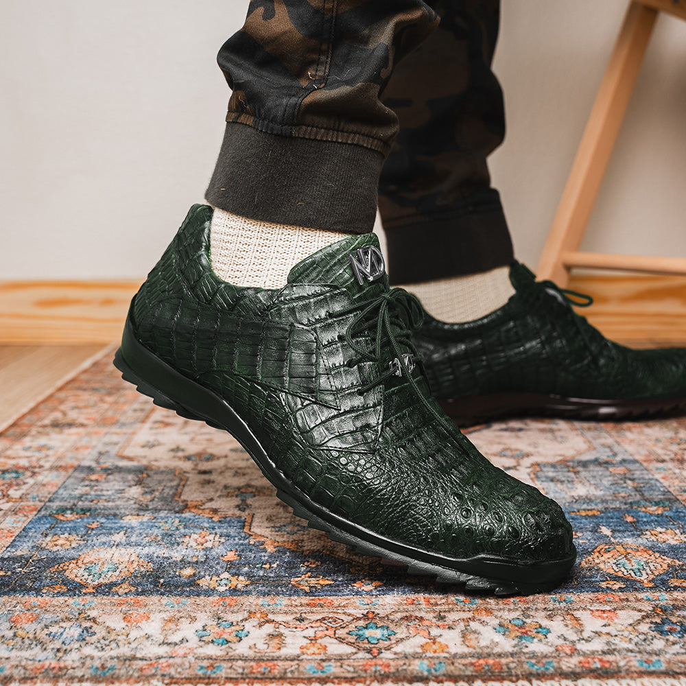 The Kratos Green by Marco Di Milano are dark green lace-up shoes crafted from textured leather with a crocodile skin pattern, black rubber soles, and a hand-painted finish for luxurious sophistication.