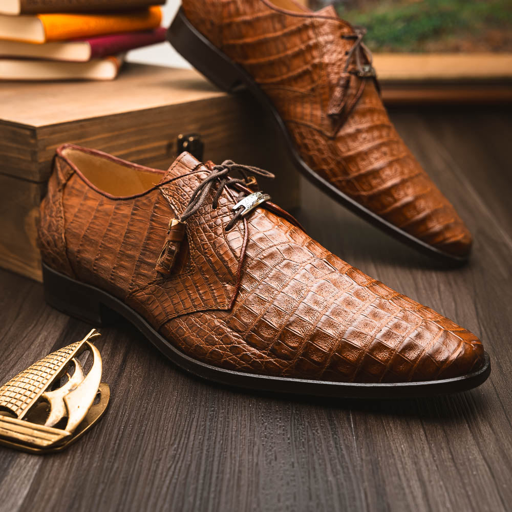 A pair of Marco Di Milano Lacio Bay Apache luxury derby shoes crafted from genuine caiman crocodile leather—one upright and the other on its side to showcase the exquisite sole.