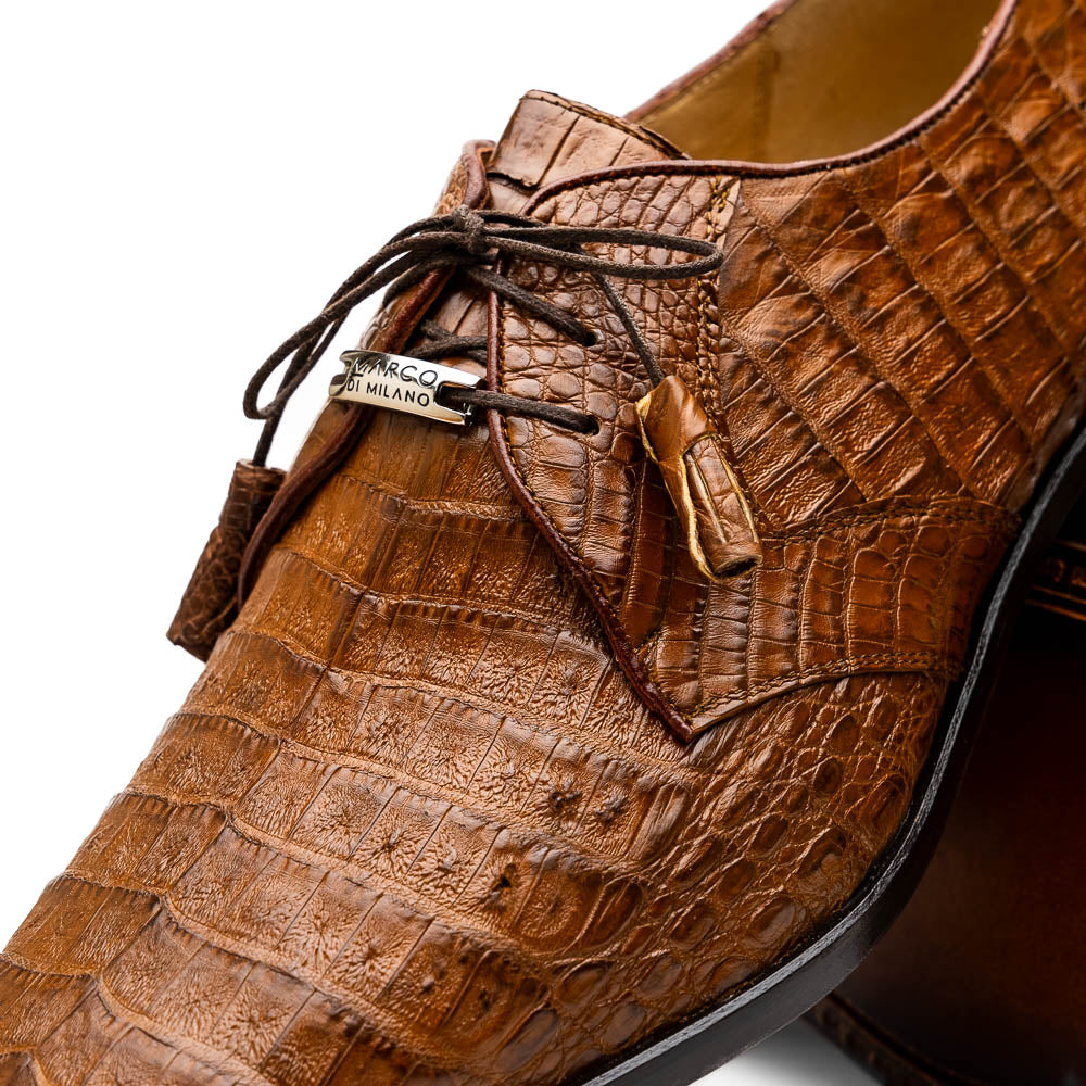 A pair of Marco Di Milano Lacio Bay Apache luxury derby shoes crafted from genuine caiman crocodile leather—one upright and the other on its side to showcase the exquisite sole.