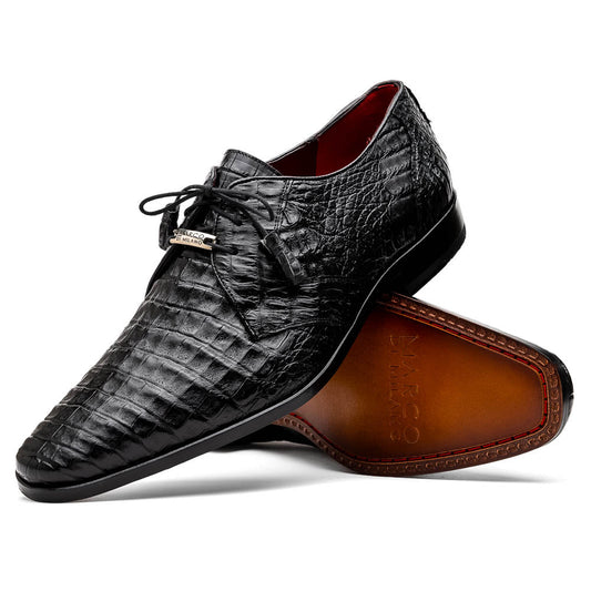 A pair of Marco Di Milano Lacio Black shoes—crafted from genuine caiman crocodile leather—one upright and one on its side, showing a brown leather sole embossed with luxury branding.
