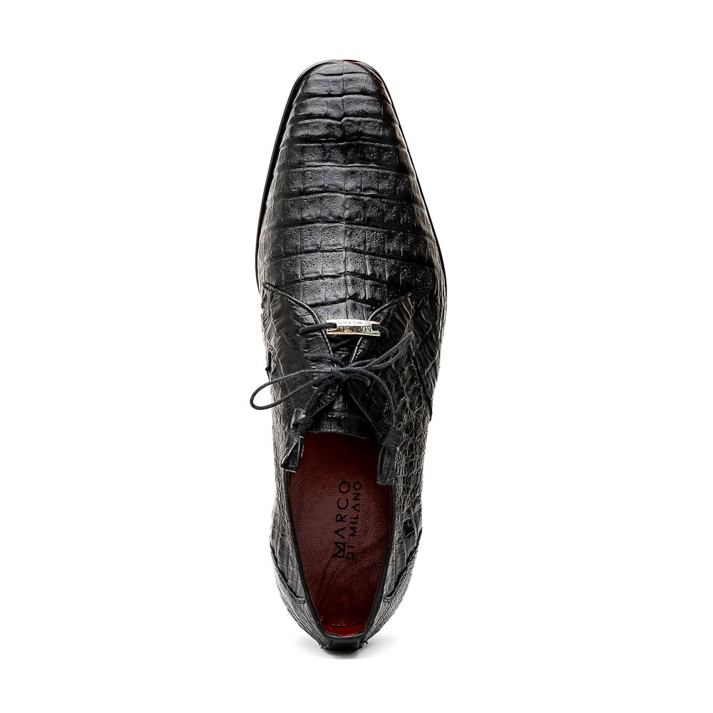 A pair of Marco Di Milano Lacio Black shoes—crafted from genuine caiman crocodile leather—one upright and one on its side, showing a brown leather sole embossed with luxury branding.