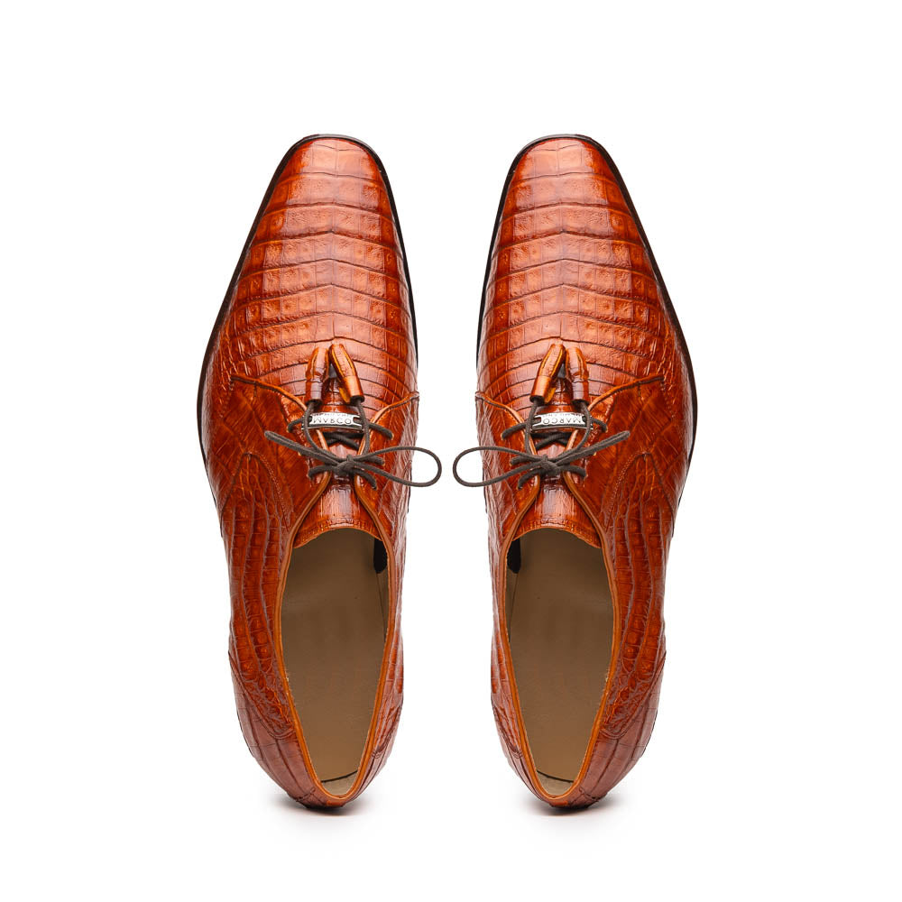 A pair of Marco Di Milano Lacio Brandy luxury derby shoes in a brown crocodile pattern, crafted from genuine caiman leather—one upright and one on its side to highlight the signature sole branding.