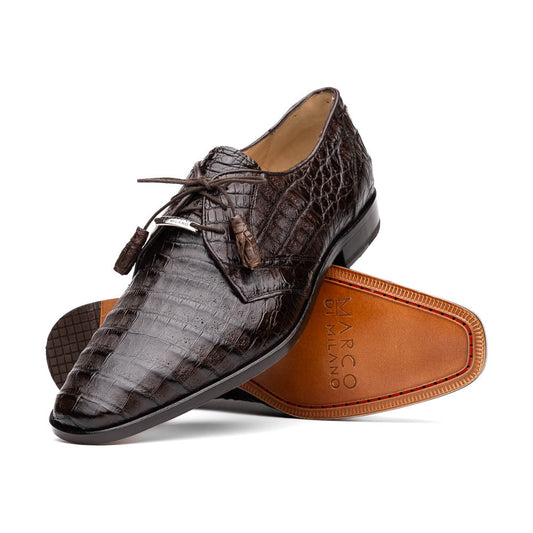 The "Lacio Brown" by Marco Di Milano is a luxury men's dress shoe made from genuine caiman crocodile leather, featuring tassel laces and the brand's logo—presented with one shoe resting atop the other.
