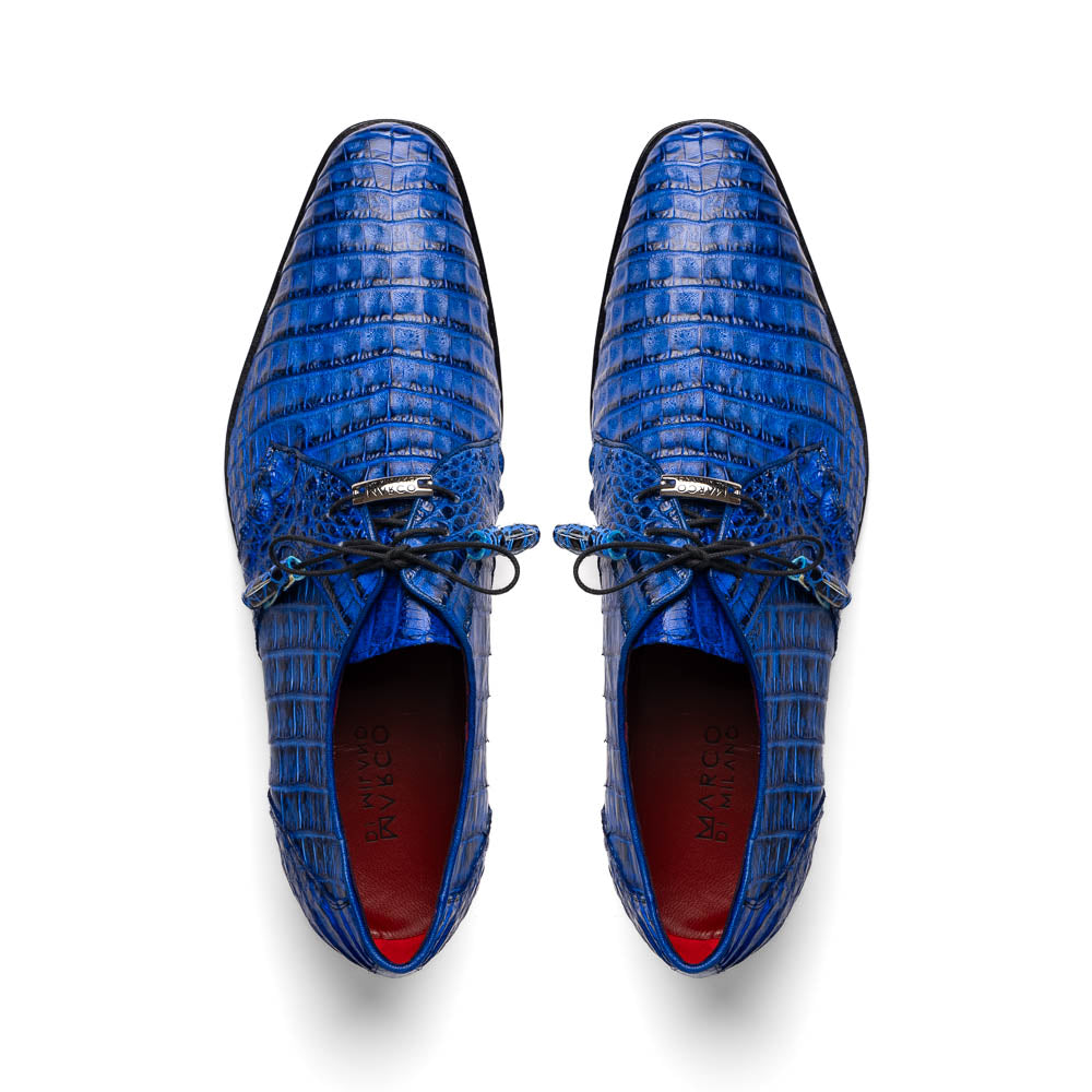 Marco Di Milano’s Lacio Electric Blue men’s dress shoes feature genuine caiman crocodile leather in blue, black laces, a bold red interior, with one shoe standing upright and the other lying on its side.