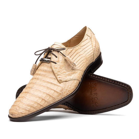 A pair of beige Marco Di Milano Lacio Orix shoes in genuine caiman crocodile, featuring a luxury derby design with dark brown laces—one upright, the other on its side to display the detailed sole.