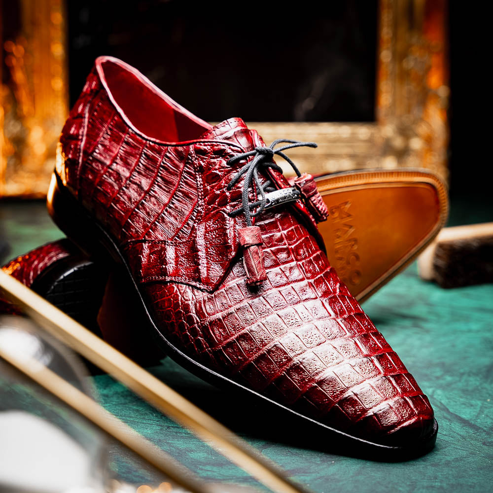 The Lacio Wine by Marco Di Milano is a luxury men's dress shoe crafted from brown genuine caiman crocodile leather, featuring a red inner lining, black laces, and "Marco Di Milano" branding on the tan leather sole.