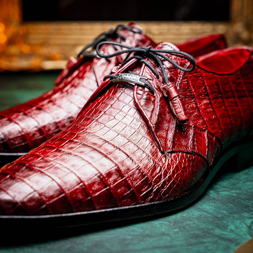 The Lacio Wine by Marco Di Milano is a luxury men's dress shoe crafted from brown genuine caiman crocodile leather, featuring a red inner lining, black laces, and "Marco Di Milano" branding on the tan leather sole.