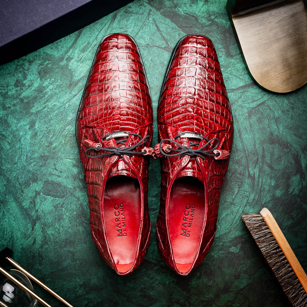 The Lacio Wine by Marco Di Milano is a luxury men's dress shoe crafted from brown genuine caiman crocodile leather, featuring a red inner lining, black laces, and "Marco Di Milano" branding on the tan leather sole.