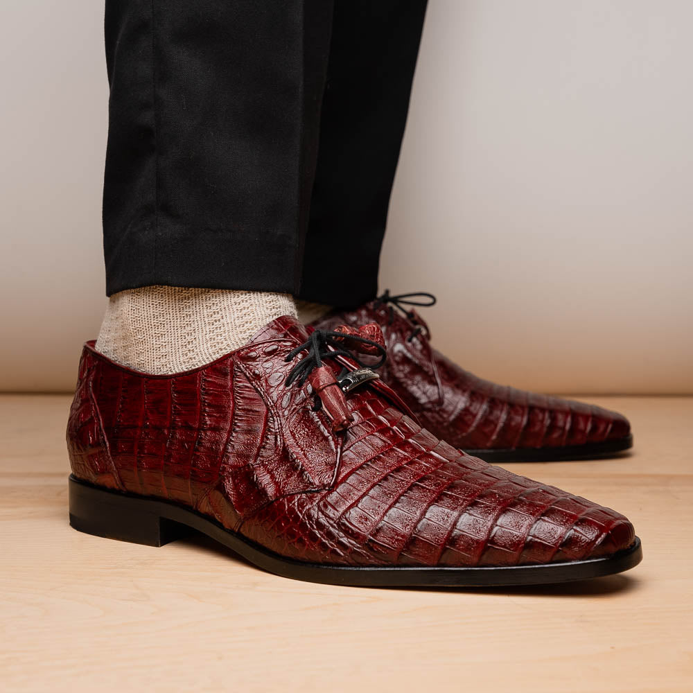 The Lacio Wine by Marco Di Milano is a luxury men's dress shoe crafted from brown genuine caiman crocodile leather, featuring a red inner lining, black laces, and "Marco Di Milano" branding on the tan leather sole.