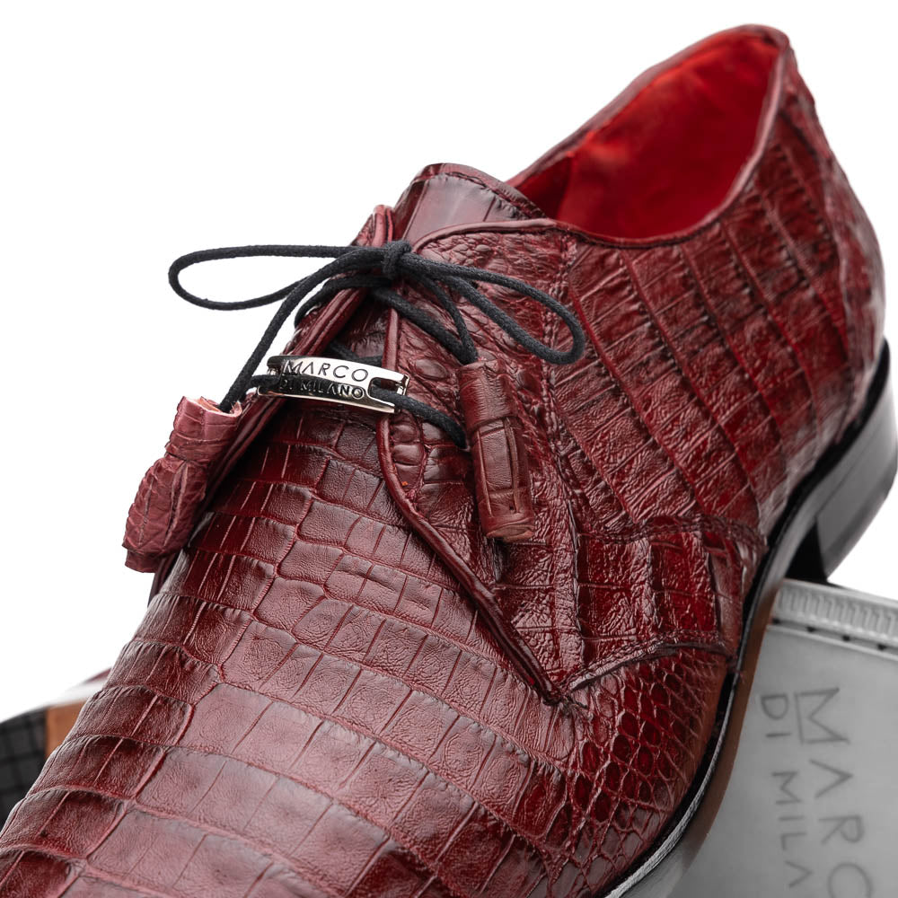 The Lacio Wine by Marco Di Milano is a luxury men's dress shoe crafted from brown genuine caiman crocodile leather, featuring a red inner lining, black laces, and "Marco Di Milano" branding on the tan leather sole.